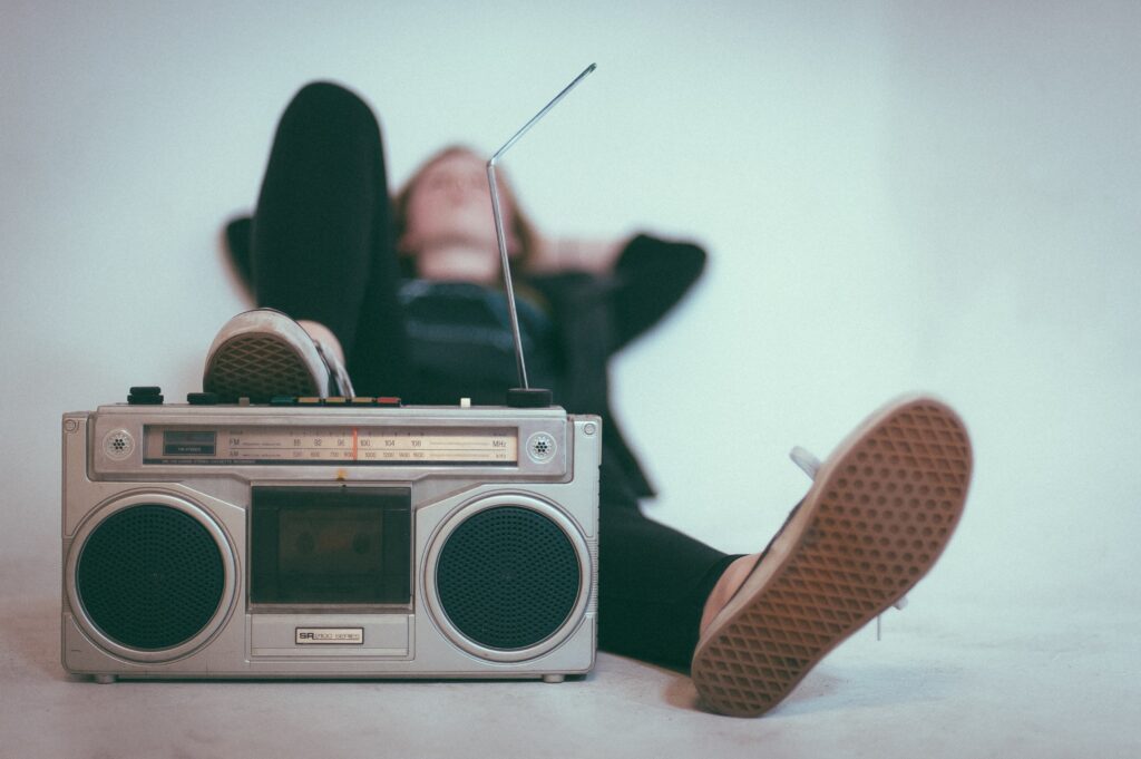 individual relaxing listening to a boom box